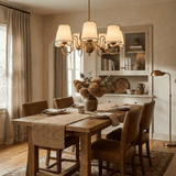 Scalloped Shade Curated Solid Brass Chandelier installed in residential dining space