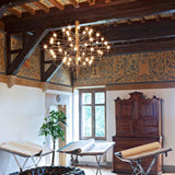 Tiered Branch Curated Solid Brass Chandelier – illuminated warm ambiance setting