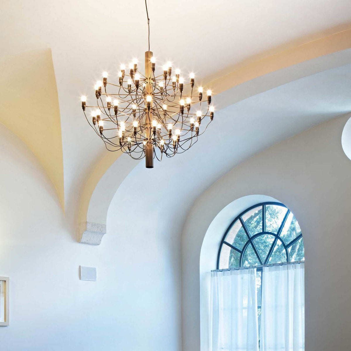 Tiered Branch Curated Solid Brass Chandelier warm illuminated room view