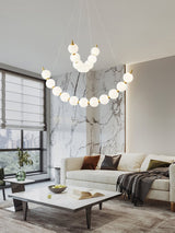 Acrylic Pearls Curated Solid Brass Chandelier warm illuminated room view