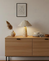 Auralin Curated Yellow Travertine Table Lamp – illuminated warm ambiance setting