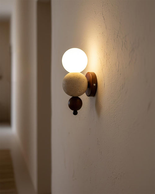 Balvano Curated Yellow Travertine Wall Sconce installed in residential dining space