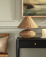 Baskora Curated Woven Rattan Table Lamp warm illuminated room view