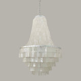 Boho Shell Tiered Curated Iron & Glass Chandelie – illuminated warm ambiance setting