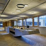 Circular Curated Iron & Glass Chandelier warm illuminated room view
