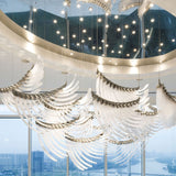 Pluma Sculptural Feather Chandelier warm illuminated room view