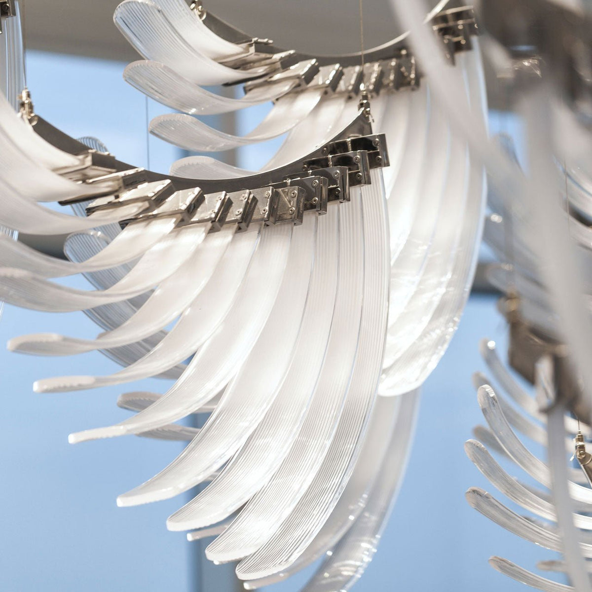 Pluma Sculptural Feather Chandelier – illuminated warm ambiance setting