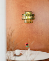 Cendrel Curated Amber Art Glass Wall Sconce installed in residential dining space