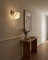 Eala Alabaster Curated Alabaster Wall Sconce warm illuminated room view