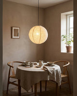 Mirevon Curated Finished Iron Pendant Light warm illuminated room view