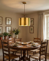 Pomeline Curated Solid Brass Pendant Light warm illuminated room view