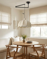 Ruffle Swing Arm Curated Finished Iron Pendant L – spatial dining room perspective