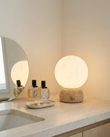Savio Curated Yellow Travertine Table Lamp – illuminated warm ambiance setting