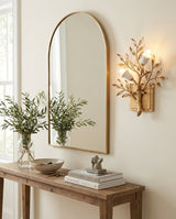 Sylvara Curated Solid Brass Wall Sconce warm illuminated room view