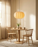 Elunor Curated Finished Iron Pendant Light warm illuminated room view
