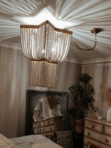Estrella Curated Iron & Glass Chandelier warm illuminated room view