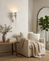 Fanoria Curated Iron & Glass Wall Sconce warm illuminated room view