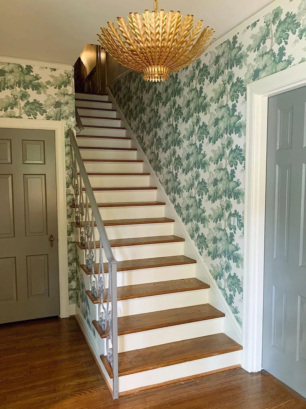 Gilded Acanthus Curated Iron & Glass Chandelier warm illuminated room view