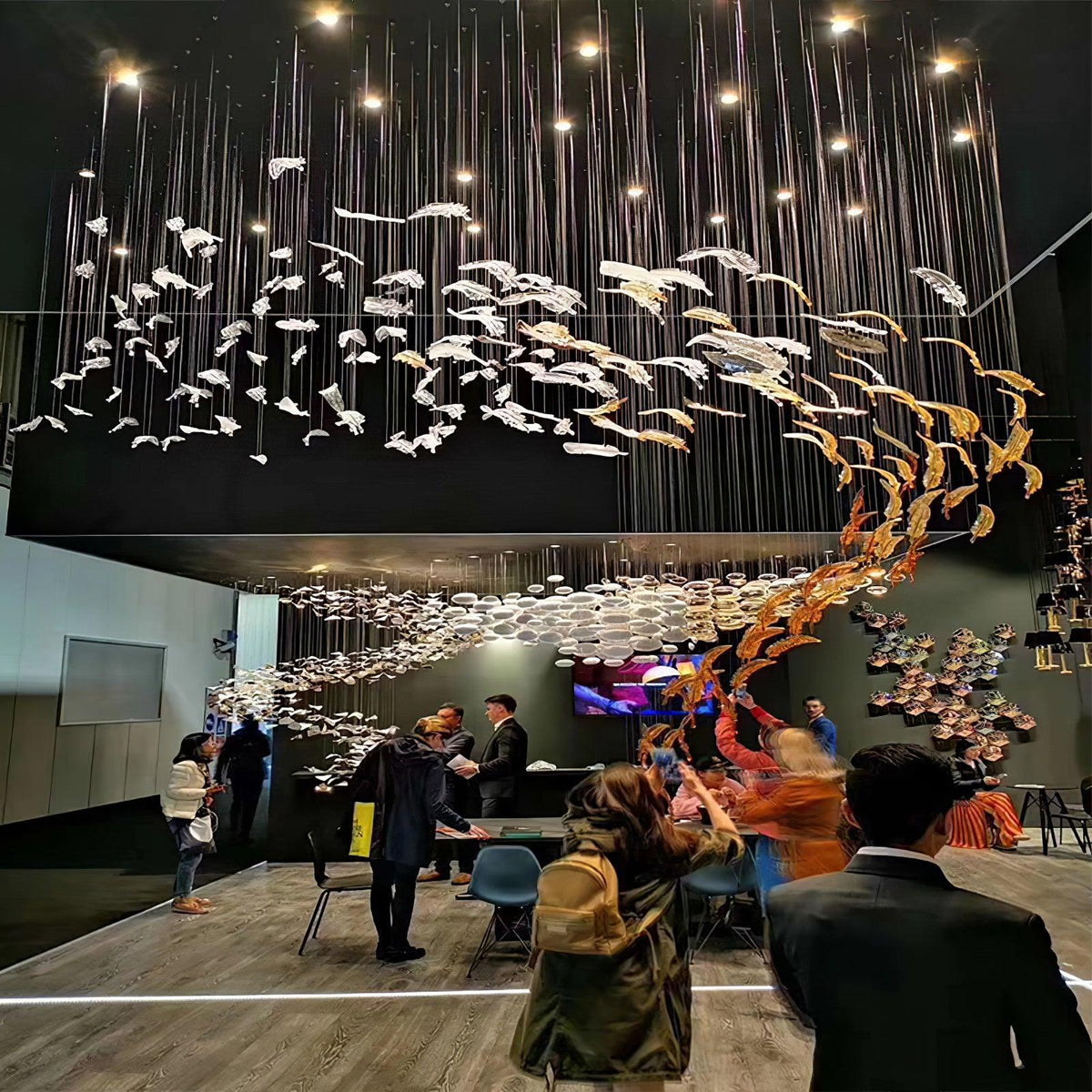Pluma Sculptural Feather Chandelier warm illuminated room view