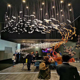 Pluma Sculptural Feather Chandelier warm illuminated room view