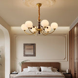 Livia Curated Mouth-Blown Frosted Glass Chandeli warm illuminated room view
