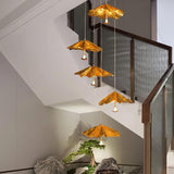 Golden Ginkgo Spiral Curated Solid Brass Chandel installed in residential dining space