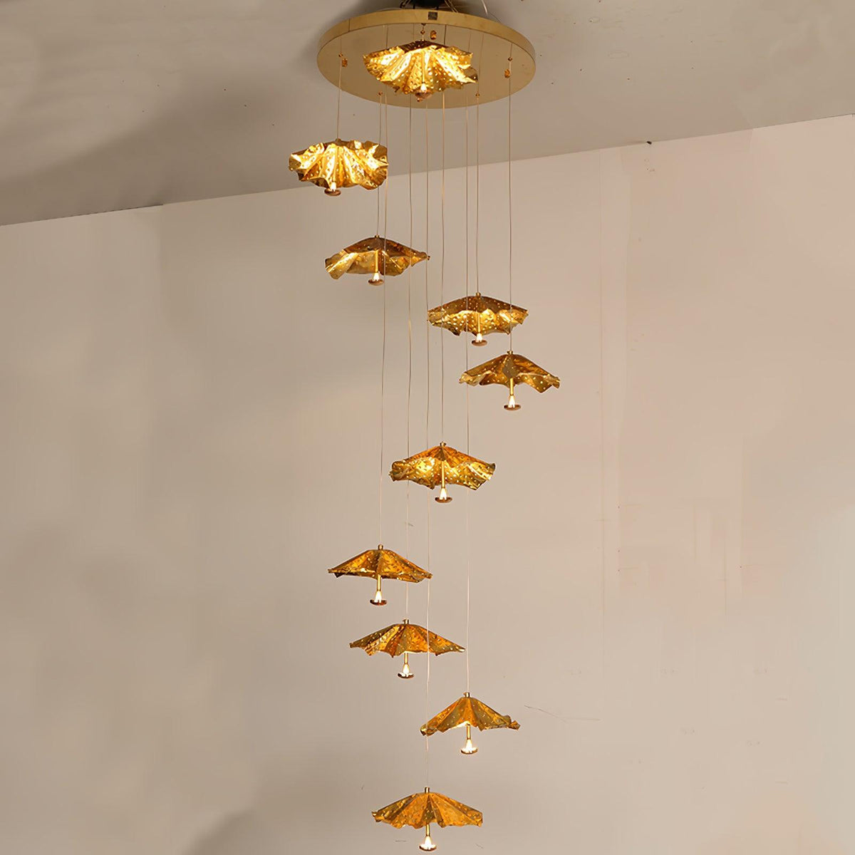 Golden Ginkgo Spiral Curated Solid Brass Chandel – illuminated warm ambiance setting