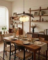 Lunova Curated Mouth-Blown Frosted Glass Pendant warm illuminated room view