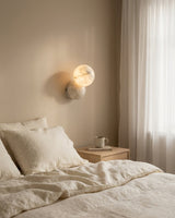 Orb Alabaster Curated Alabaster Wall Sconce warm illuminated room view