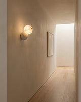 Orb Alabaster Curated Alabaster Wall Sconce – illuminated warm ambiance setting