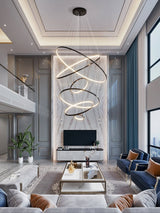 Orrery Rings Curated Solid Brass Chandelier – spatial dining room perspective