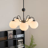 Renee Curated Mouth-Blown Frosted Glass Chandeli warm illuminated room view