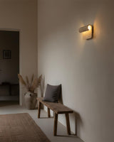 Rolix Curated Yellow Travertine Wall Sconce – illuminated warm ambiance setting