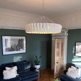 Shard Curated Mouth-Blown Frosted Glass Chandeli warm illuminated room view