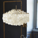 Round Shell Curated Iron & Glass Chandelier – illuminated warm ambiance setting