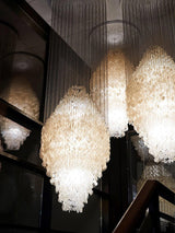 Shell Waterfall Curated Iron & Glass Chandelier – illuminated warm ambiance setting