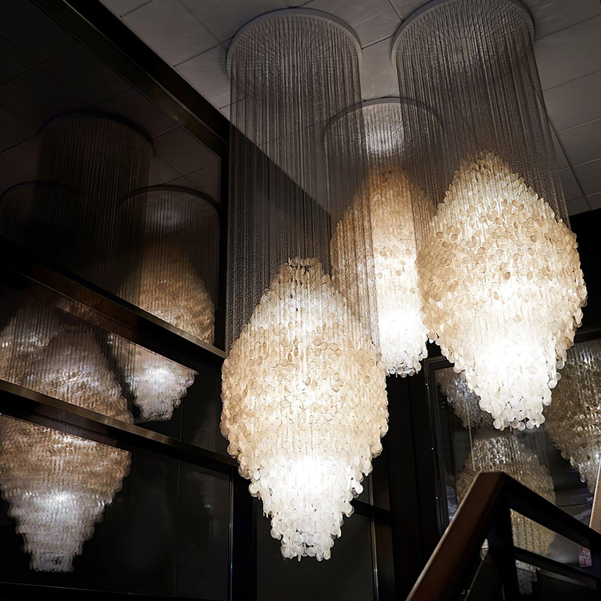 Shell Waterfall Curated Iron & Glass Chandelier installed in residential dining space