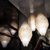 Shell Waterfall Curated Iron & Glass Chandelier installed in residential dining space