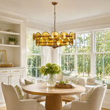 Solaris Disc Murano Curated Amber Art Glass Chan installed in residential dining space