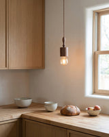 Tavik Curated Solid Hardwood Pendant Light – illuminated warm ambiance setting