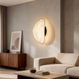 JINSHE Silk & Metal Wall Sconce - Illuminated view demonstrating the soft, ambient light in a cozy bedside reading nook.