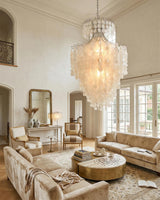 Tirenza Shell Curated Iron & Glass Chandelier – illuminated warm ambiance setting