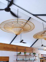 Troy Lighting Costa Mesa Curated Woven Rattan Ch installed in residential dining space