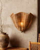 Vera Rattan Curated Woven Rattan Wall Sconce warm illuminated room view
