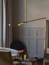 Wrapped Linear Curated Solid Brass Chandelier installed in residential dining space
