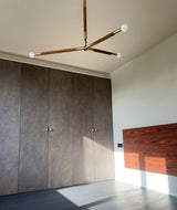Wrapped Linear Curated Solid Brass Chandelier warm illuminated room view